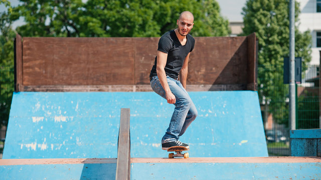 Skateboarder preparing to do a skateboard trick at skate park.