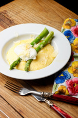 Slices of tasty corn polenta with egg,asparagus and hard cheese