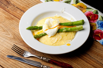 Slices of tasty corn polenta with egg,asparagus and hard cheese