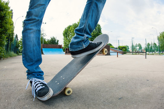 Man riding skateboard at skatepark, low angle view with fish eye
