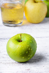 Green apple and glass of juice