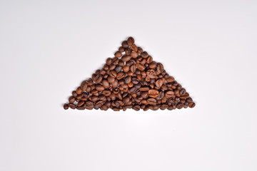 Triangle shape of roasted coffee beans on white background. Love