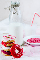 Breakfast with homemade colorful donuts and milk