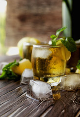 Glass of whiskey with mint and lemon