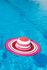 Fototapeta na wymiar Pink sunhat at swimming pool