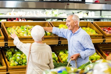 Senior couple picking out fruits together