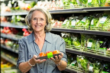 Senior woman picking out some vegetables