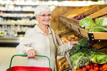 Senior woman picking out some vegetables