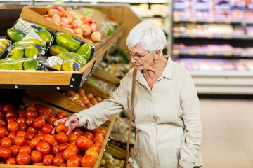 Senior woman choosing her tomatoes