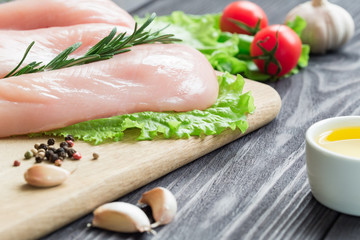 Chicken fillet on a cutting board.