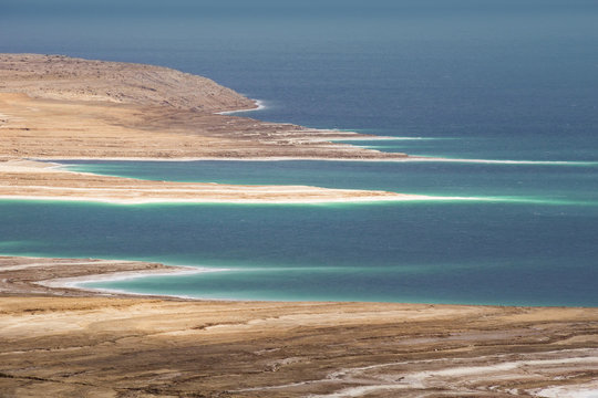 dead sea shoreline and deep blue water