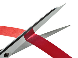 Old and rusty Scissors cutting a red ribbon. clipping path