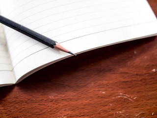 Notebook and pencil on the table