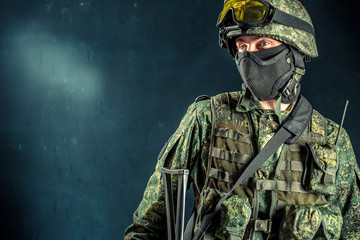 Special forces soldier with rifle on dark background
