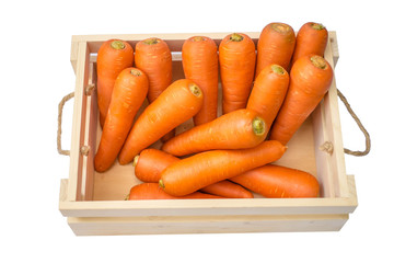 carrots in wooden box isolated