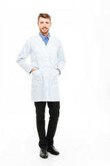 Male doctor standing and looking at camera