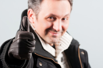 Fototapeta premium Closeup of attractive man thumb up and smile