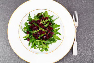 Dietary food without meat: Salad with arugula and beet.