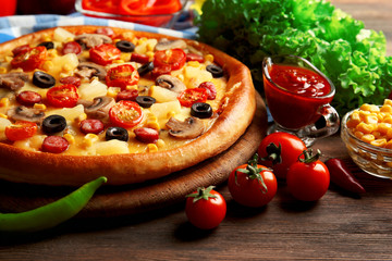 Delicious pizza with vegetables and meat, close-up