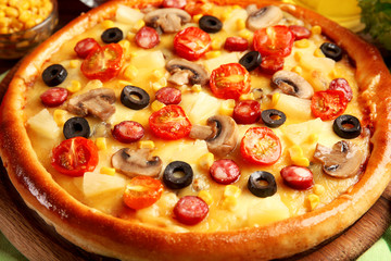 Delicious pizza with vegetables and meat, close-up