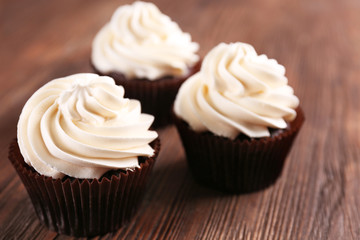 Chocolate cupcakes on wooden background