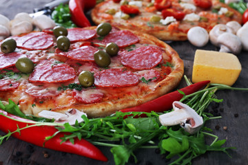 Delicious tasty pizza with ingredients on table, closeup