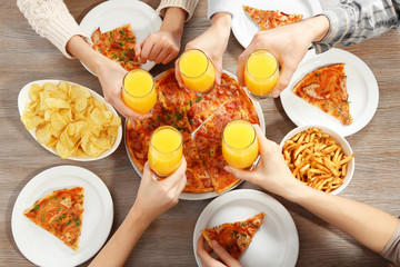 Friendly party with hot pizza and drinks, close up