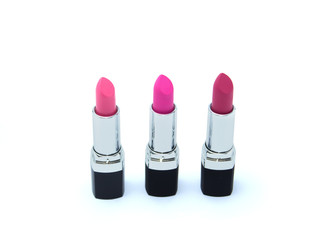 Three pink lipsticks in black case isolated on white