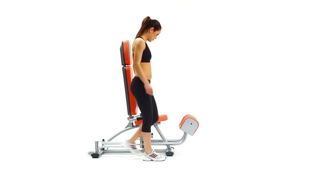 Athletic brunette woman on hydraulic exerciser