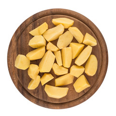 Sliced, peeled raw potatoes on a board
