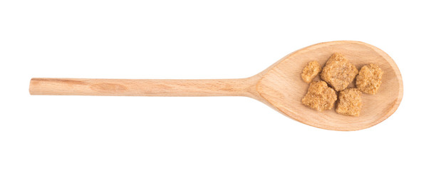 Cubes of cane sugar with wooden spoon