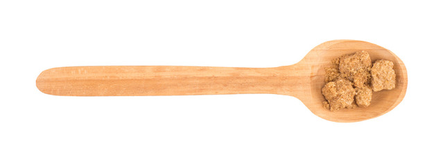 Cubes of cane sugar with wooden spoon
