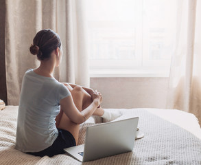 Young woman at home with laptop