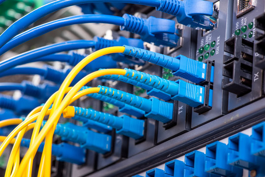 Fiber Optic cables connected to an optic ports and Network cable