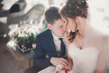 closeup groom kissing bride's shoulder