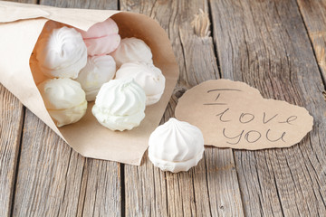 Love message concept, sweets and heart on rustic table