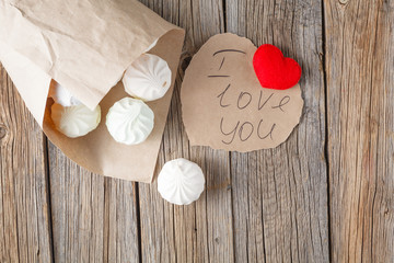 Pastel colored marshmallow on a wooden table