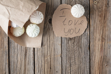 Pile of pastrel colored marshmallow on wooden table