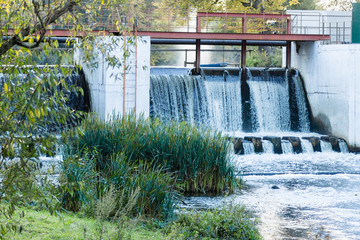 The water stream flows through a concrete dam on the river Desna.