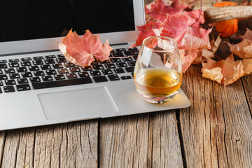 glass with whiskey on wooden table