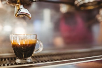 Close up of cup on a coffee machine