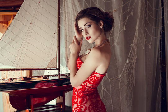 Beautiful lady in red dress in the restaurant.