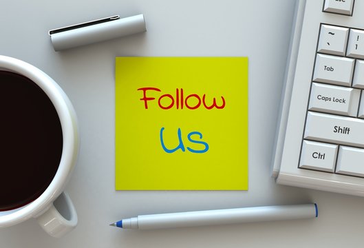 Follow Us, message on note paper, computer and coffee on table
