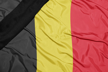 national flag of belgium with black mourning ribbon