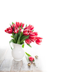 Bouquet of pink tulips in vase on the white background