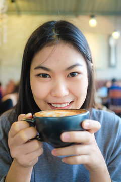 Woman smiling with coffee cup