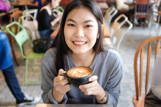 Woman smiling with coffee cup
