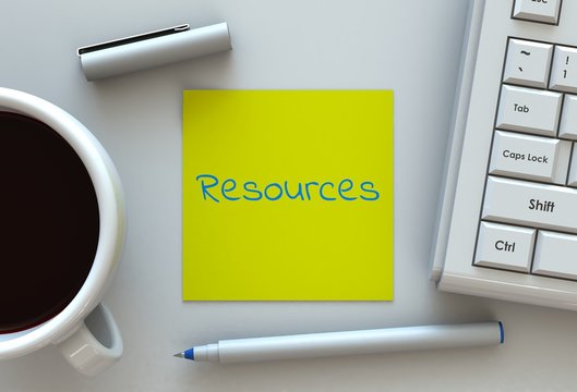 Resources, message on note paper, computer and coffee on table