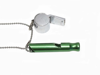 Whistles and chain on white background