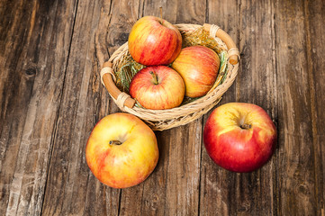 Ripe apples on grunge wooden background